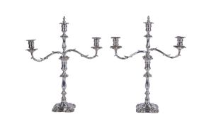 A pair of Edwardian electro-plated two branch three light candelabra by Elkington & Co.