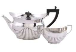 A late Victorian silver navette shape tea pot by The Goldsmiths & Silversmiths Co. Ltd