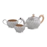 ϒ A Victorian silver and ivory oval three piece bachelor's tea service by Hilliard & Thomason