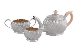 ϒ A Victorian silver and ivory oval three piece bachelor's tea service by Hilliard & Thomason