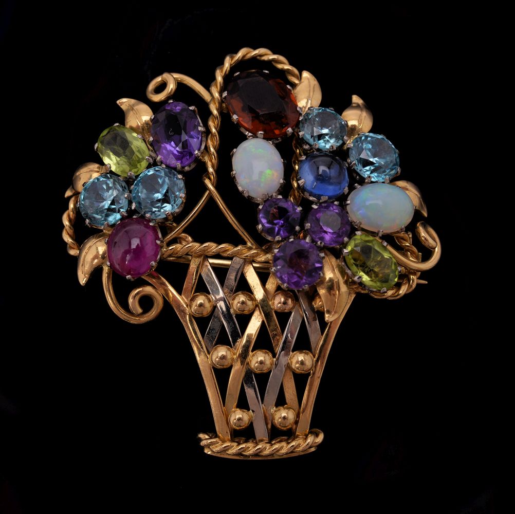 A gemset giardinetto brooch of openwork polished and ropework design with applied beads in white and