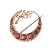 A garnet crescent brooch