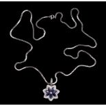 A sapphire and diamond flower head pendant