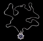 A sapphire and diamond flower head pendant