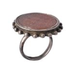 A Persian style cornelian seal and silver ring