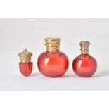 Two 19th century ruby glass spherical scent bottles and a ruby glass vinaigrette
