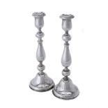 A pair of silver circular candlesticks by Joseph Gloster Ltd