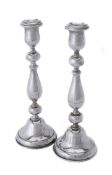 A pair of silver circular candlesticks by Joseph Gloster Ltd