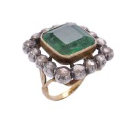 An emerald and diamond cluster ring