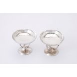 A pair of Arts and Crafts spot hammered silver pedestal dishes by James Weir