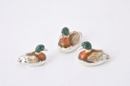 A graduated set of three silver and enamel model ducks by J A H