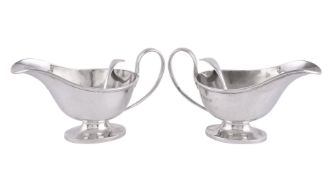 A pair of silver oval pedestal sauce boats by Horace Woodward & Co.