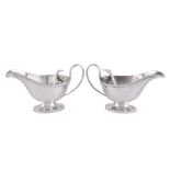 A pair of silver oval pedestal sauce boats by Horace Woodward & Co.