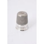 An Edwardian silver spirit measure fashioned as a thimble by Charles Horner