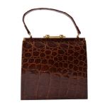 ϒ A brown crocodile leather handbag