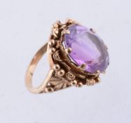 An amethyst single stone ring