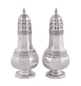 A pair of silver octagonal baluster sugar casters by W. I. Broadway & Co.