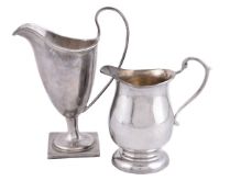 A silver helmet shape cream jug by Florence Warden