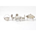 A collection of silver toys mainly furniture