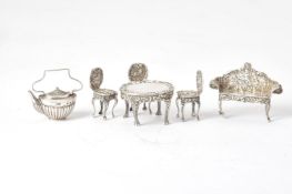 A collection of silver toys mainly furniture