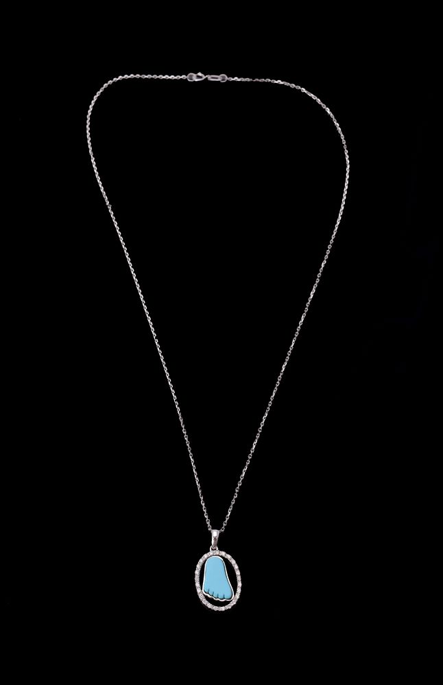 A turquoise baby foot and diamond pendant