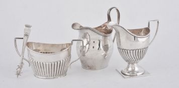 A silver swollen oval cream jug by Nathan & Hayes