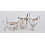 A silver swollen oval cream jug by Nathan & Hayes