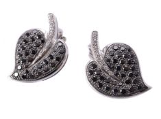 A pair of black diamond and diamond ear clips