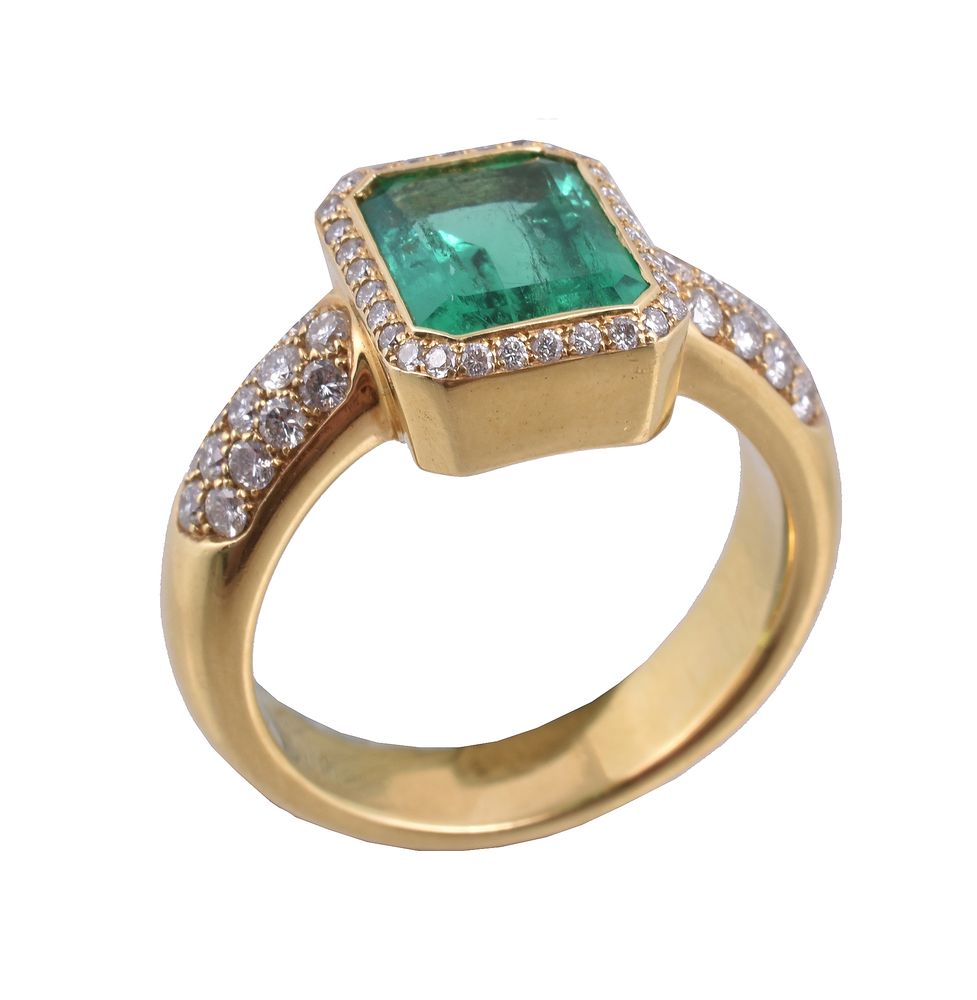 An emerald and diamond ring