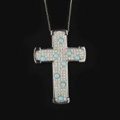 A diamond and turquoise cross pendant