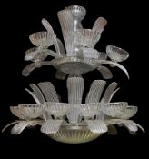 A large moulded clear glass seventeen light chandelier in Art Deco style