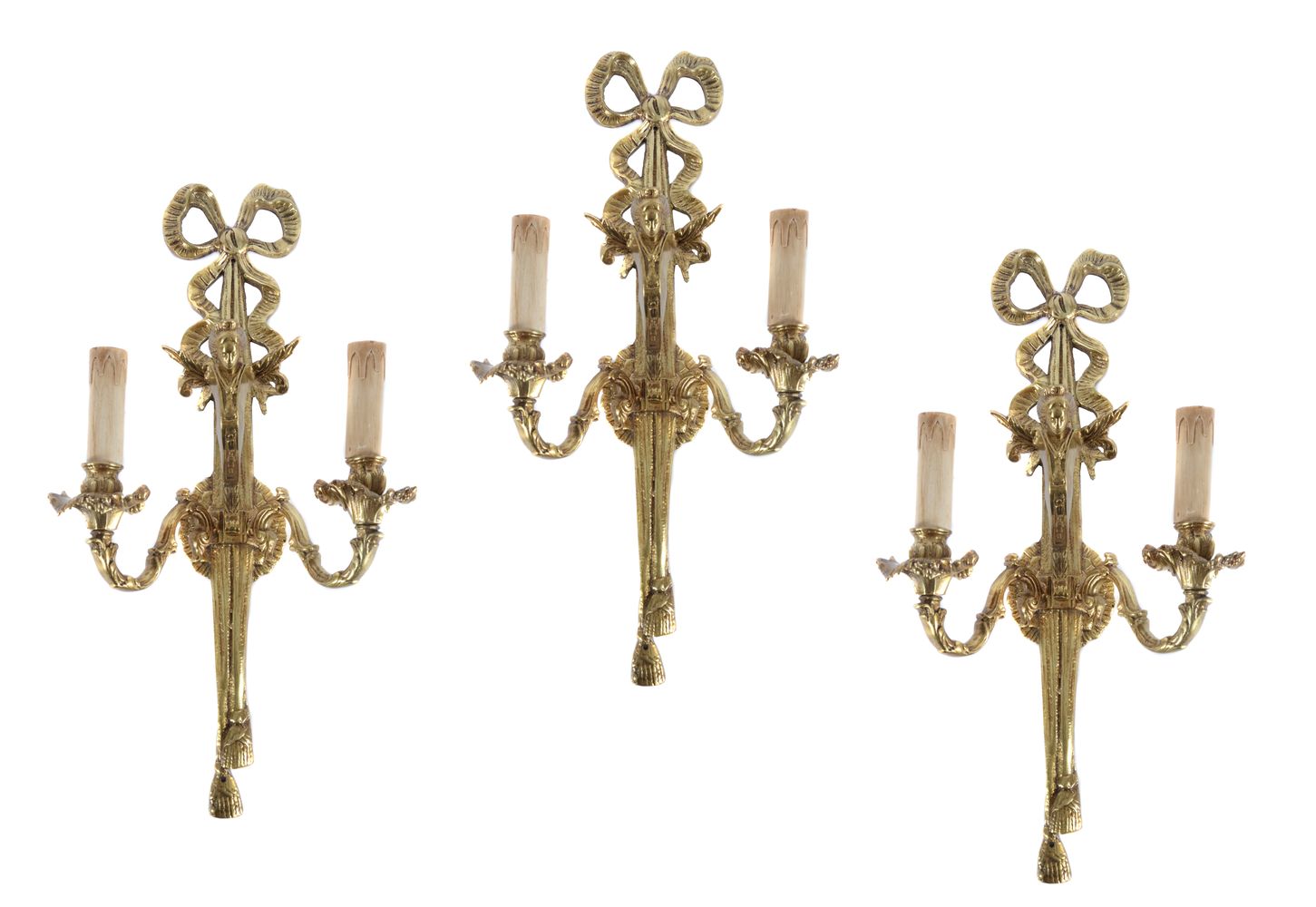 A set of three Continental gilt metal twin light wall appliques in Louis XVI taste
