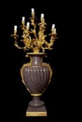 A pair of monumental ten light porphyry and gilt bronze mounted candelabra in Louis XV taste