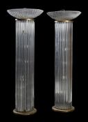 A pair of moulded glass and gilt metal mounted standard lamps in Art Deco taste