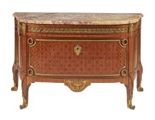 ϒ A French kingwood, marquetry inlaid, and gilt metal mounted commode in Louis XVI style