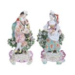 A pair of Derby porcelain bocage figures of a musician and companion