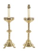A pair of late Victorian brass table lamps in the manner of altarsticks