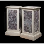 A pair of stone and fleur de pêcher marble inset plinths