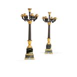 A pair of substantial Restauration gilt and patinated bronze and green serpentine marble mounted sev