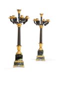 A pair of substantial Restauration gilt and patinated bronze and green serpentine marble mounted sev