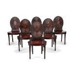 A set of six late George III mahogany hall chairs, circa 1790