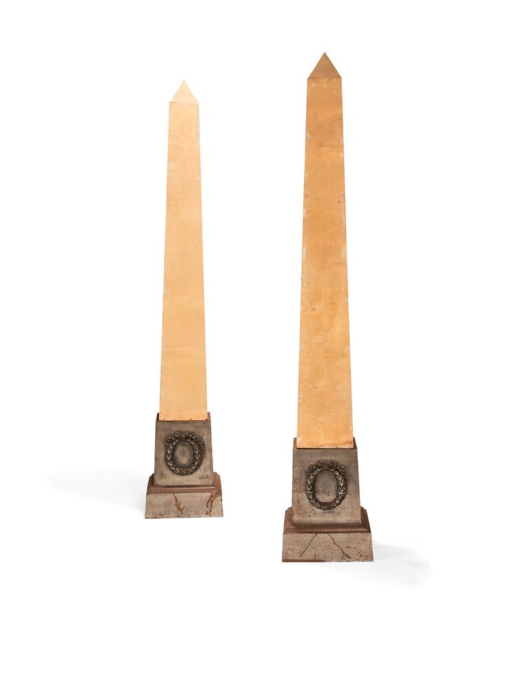 A pair of plywood and cast iron obelisk standard lamps, the plinths probably early 20th century
