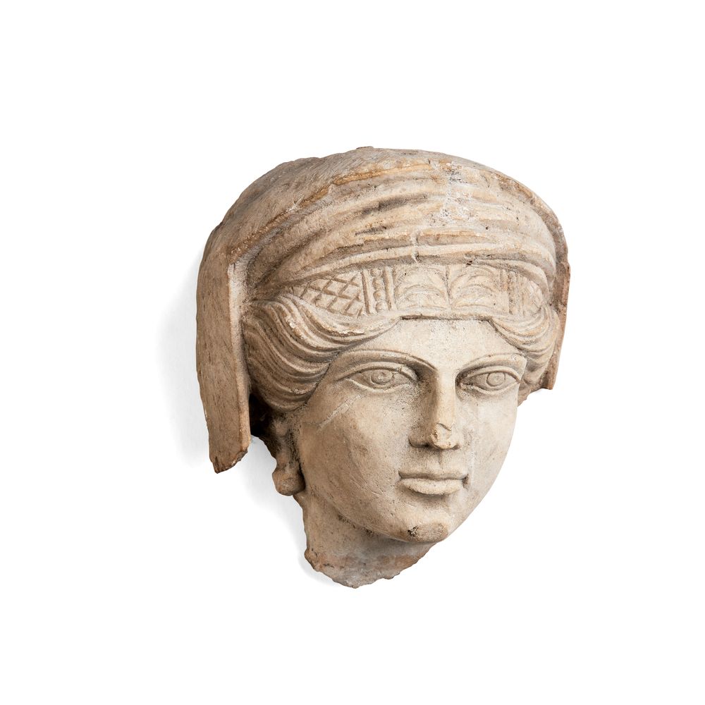 A small Roman limestone female head, Palmyra, circa AD 200-220