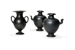 A pair of English black dry-bodied stoneware two-handled urns after the Antique, 19th century