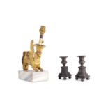 A pair of Empire patinated bronze candle holders, circa 1810, and a Regency gilt bronze mount refitt