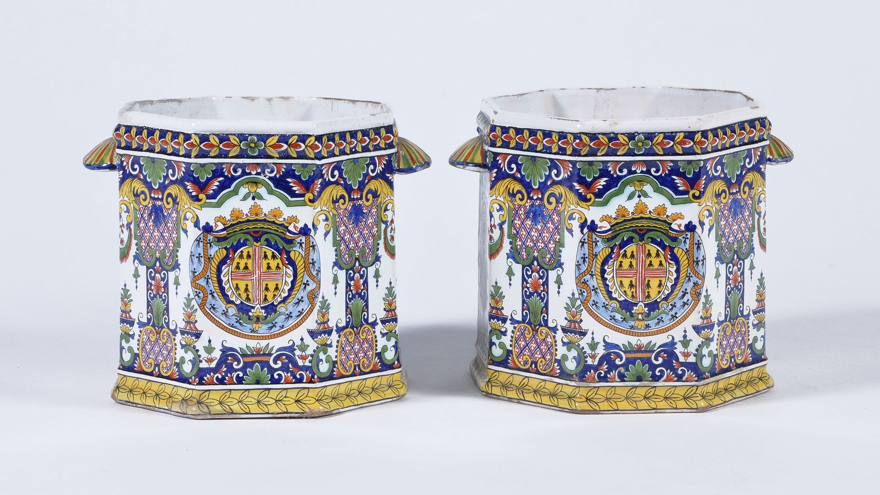 A pair of French fayence Rouen-style polychrome octagonal section bottle coolers