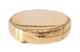 An oval pill box of plain polished finish