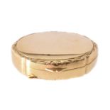 An oval pill box of plain polished finish