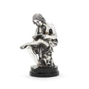 An Italian filled silver coloured figure of a seated youth reading