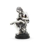 An Italian filled silver coloured figure of a seated youth reading